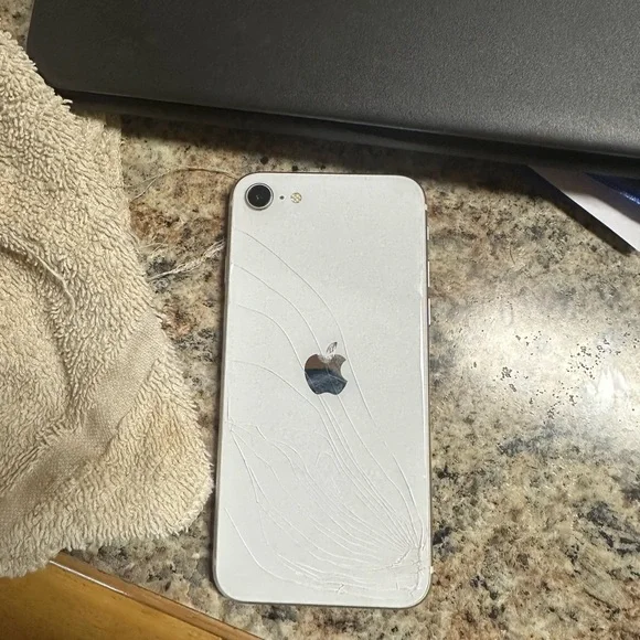 IPhone SE 64 GB through straighttalk back screen cracked but works great